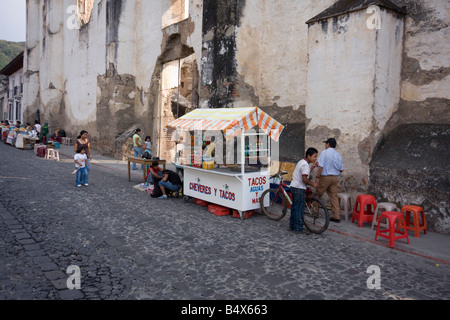 Un stand de nourriture dans une rue pavée typique dans Antigua Guatemala Banque D'Images