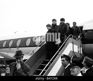 Groupe pop les Beatles Novembre 1963 John Lennon Paul McCartney George Harrison Ringo Starr les Beatles à l'aéroport de Londres sur les marches de l'avion de Belfast Banque D'Images