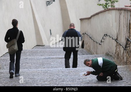 Un mendiant sur l'ancien château marches menant au château de Prague, République Tchèque Banque D'Images