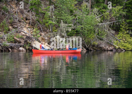 Fille et garçon canoë près de la rive du lac Clearwater parc provincial Wells Gray British Columbia Canada Banque D'Images