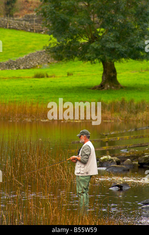 La pêche à la mouche La pêche à la ligne sur Watendlath Tarn dans le Lake District, Cumbria UK Banque D'Images