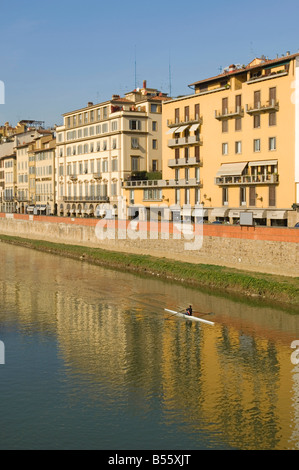 Les bâtiments sur la rue Lungarno Degli Acciauoli à Florence reflètent dans l'Arno avec un seul aviron sur l'eau. Banque D'Images