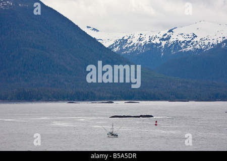 Bateau de pêche commerciale au chalut les eaux du passage intérieur entre Seattle et l'Alaska en face d'une montagne Banque D'Images