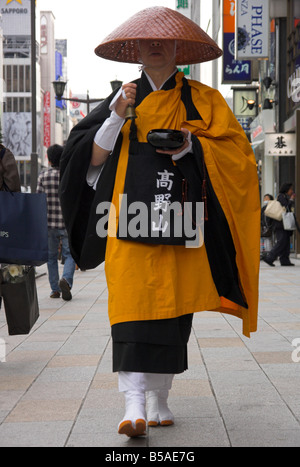 Moine shintoïste en costume traditionnel de marcher sur la chaussée la collecte de dons, Ginza, Tokyo, Honshu, Japan Banque D'Images