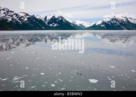 La glace de glacier Hubbard s'écoule au-delà des montagnes enneigées en désenchantement Bay et Bay Yakutat en Alaska Banque D'Images