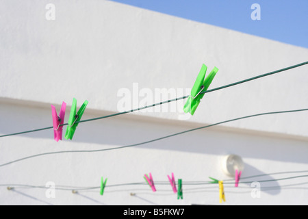 Tissu coloré pegs hanging on a wire Banque D'Images