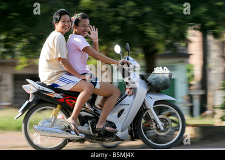 Smiling mother and daughter riding a motorcycle, Khao Sok, Thaïlande Banque D'Images