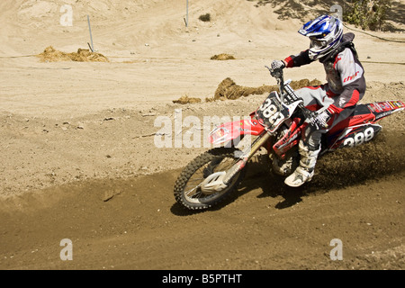 Cross rider déferle sur un coude à Glen Helen Devore circuit en Californie. Banque D'Images