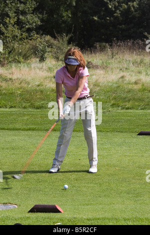 Femme golfeur dame personne conduite Balle de la TEE à jouer au golf Banque D'Images