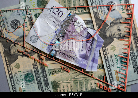 Livre Sterling endommagé sur un fond de US Dollars Banque D'Images