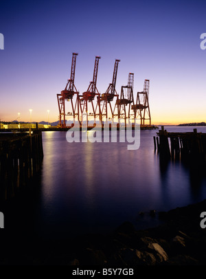 Image rétro du port de Seattle au coucher du soleil avec de grandes grues dans une rangée Seattle Waterfront Seattle Washington State USA Banque D'Images