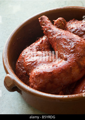 Faire mariner les cuisses de poulet en pâte Tandoori Banque D'Images