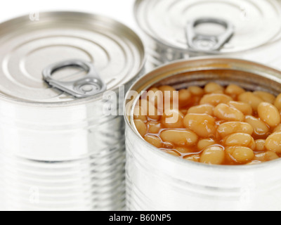 Ouverture du pot d'haricots cuits en sauce tomate prête à cuire isolé sur un fond blanc avec aucun peuple et un chemin de détourage Banque D'Images