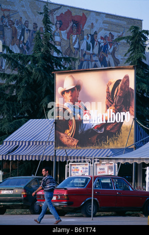 Cigarettes de Marlboro annonce billboard, et le Musée National d'histoire (avec les Albanais de l'Histoire victorieuse façade en mosaïque. Banque D'Images