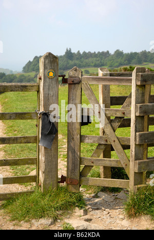 Baisers à charnière porte avec panneau 'Le Dales way' sur le post et les champs et les bois au-delà. Lake District Banque D'Images