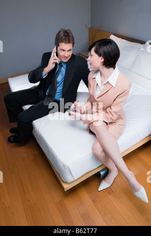 Portrait of a businesswoman using mobile phones Banque D'Images