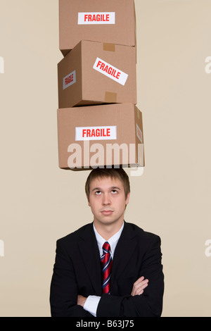 Young Woman balancing boxes on head Banque D'Images