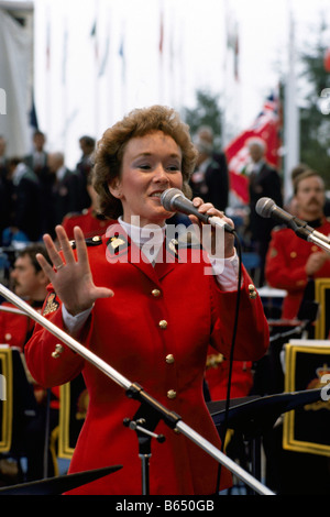 Un policier canadien (GRC) Agent de la Gendarmerie royale du Canada portant des uniformes et les surtensions rouge traditionnel de chanter sur scène Banque D'Images