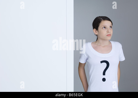 Preteen girl wearing tee-shirt imprimé avec point d'interrogation, jusqu'à Banque D'Images