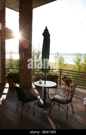 Une table et des chaises au coucher du soleil sur une terrasse Banque D'Images