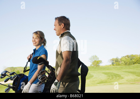 Couple Walking on Golf Course Banque D'Images