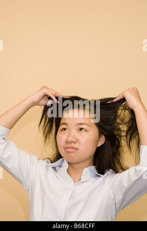 Close-up of a young woman holding her hair Banque D'Images