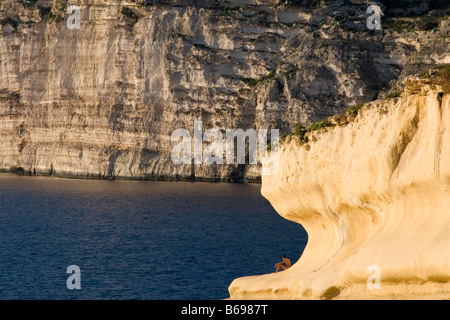 Falaise de calcaire érodé en une vague par le vent à Xlendi Bay sur la côte sud de Gozo, Malte. Banque D'Images