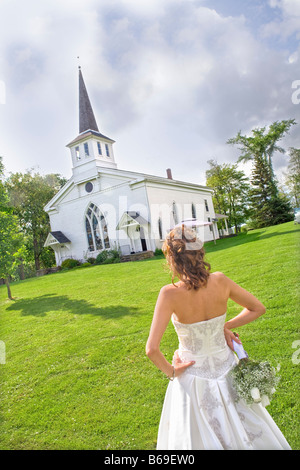Bride standing près d'une église, à l'Est Meredith, New York State, USA Banque D'Images