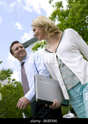 Low angle view of businessman and businesswoman smiling Banque D'Images