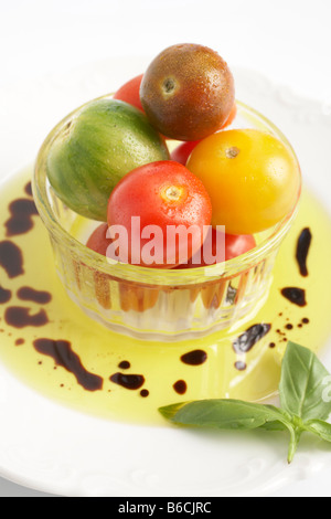 Close-up de légumes dans un bol avec de l'huile sur le plateau Banque D'Images