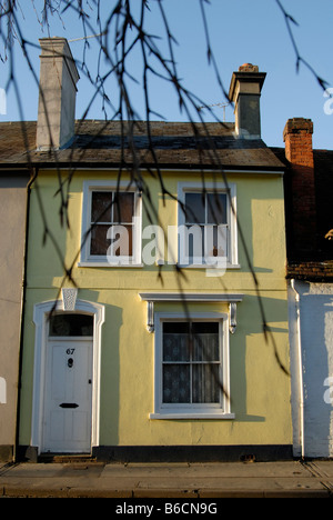 Joli Cottage géorgien début jaune vue à travers les branches d'arbres, West Street, Farnham, Surrey, Angleterre Banque D'Images