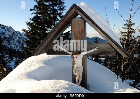 Par la neige de la route de culte avec une figure du Christ, Mt. Aschau, Kampenwand, Chiemgau, Alpes bavaroises, Bavaria, Germany, Europe Banque D'Images