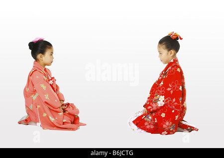 Les filles en kimono assis face à face Banque D'Images