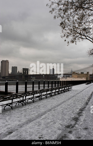 Bancs couverts de neige sont vus sur une promenade à Brooklyn, New York après une tempête. Banque D'Images