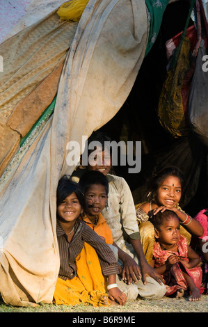 Les enfants Indiens nomades pauvres assis dans leur tente accueil dans la lumière du matin. L'Andhra Pradesh, Inde Banque D'Images