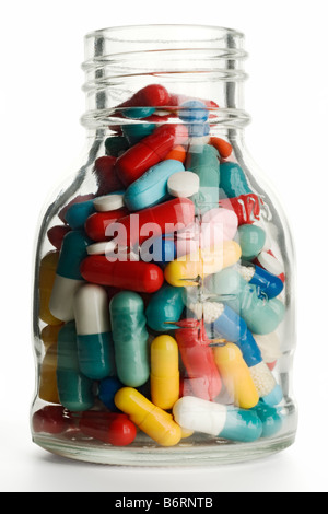 Pilules colorées dans un bocal en verre Banque D'Images