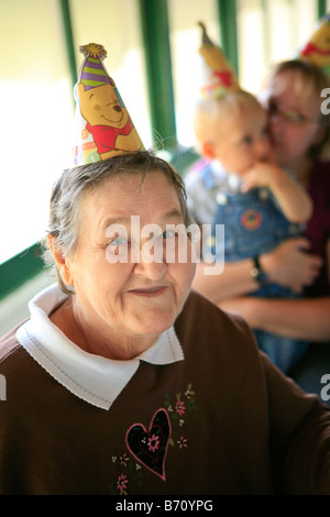 Femme âgée à kids Birthday party Banque D'Images