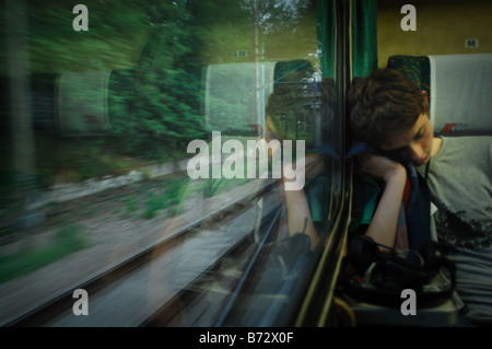 Jeune homme endormi sur un voyage en train de Varsovie à Cracovie en Pologne Banque D'Images