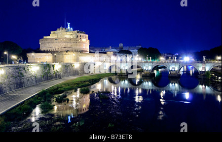 ROME, Italie - les lumières du Castel Sant'Angelo et du pont à côté se reflètent sur les eaux calmes du Tibre à Rome, Italie. Banque D'Images