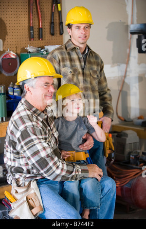 Multi-generation family wearing hardhats Banque D'Images