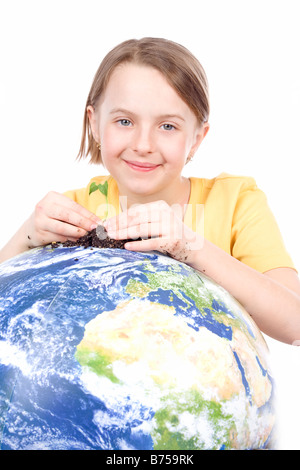 Fille de 9 ans avec la petite plante sur le globe, Winnipeg, Manitoba Banque D'Images