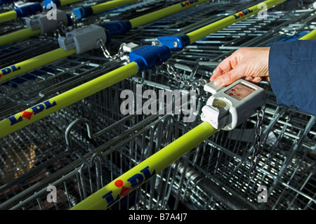 Sur une chaîne de déverrouillage femme Lidl supermarché panier Angleterre Banque D'Images