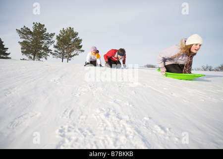 3 enfants (14, 13 et 9 ans) en bas de la colline, Winnipeg, Canada Banque D'Images