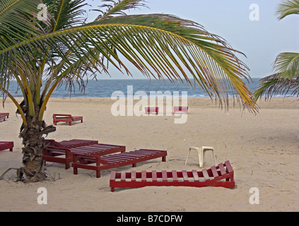 Chaises longues sur une plage de la Gambie, Afrique de l'Ouest. Banque D'Images