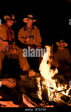 Trois cowboys autour d'un feu de camp Banque D'Images