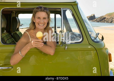 Femme assis dans le camping-car avec de la crème glacée Banque D'Images