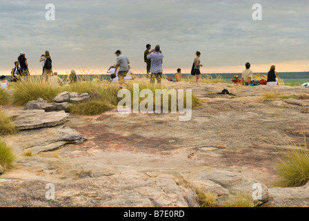 Les touristes de prendre dans un coucher de soleil avec vue sur la plaine d'Ubirr Nardab dans le Kakadu National Park Banque D'Images