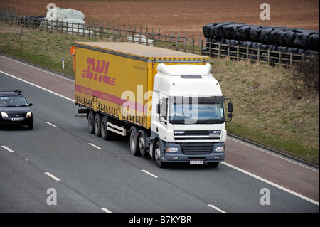 DAF CF85 trois essieux camion avec remorque à essieu tri curtainsided DHL sur autoroute Banque D'Images