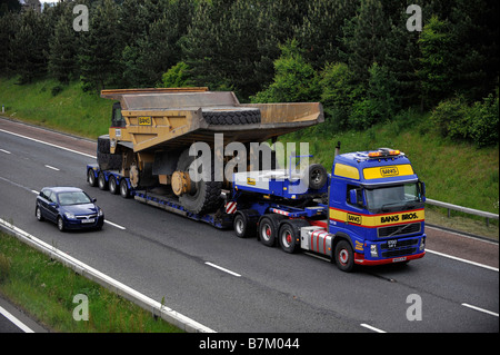 Volvo FH banques transport lourd camion transportant un camion géant large charge anormale sur l'autoroute Banque D'Images