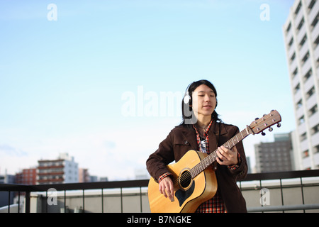 Jeune homme jouant de la guitare Banque D'Images